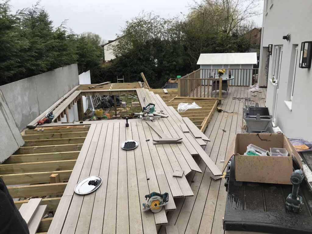 Timber decking installation under construction with tools and framework visible