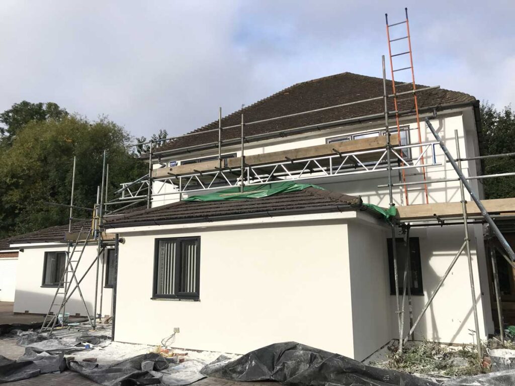 Exterior rendering project with scaffolding showing smooth finished walls